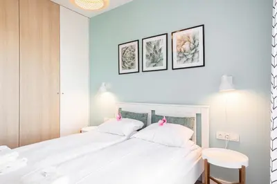 Łóżko lub łóżka w pokoju w obiekcie Apartment Walońska with FREE PARKING Wrocław by Noclegi Renters