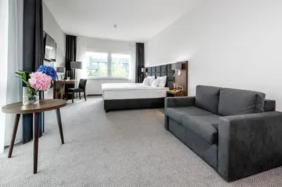 Łóżko lub łóżka w pokoju w obiekcie DB Hotel Wrocław