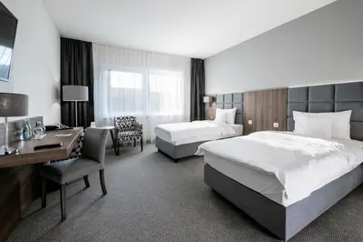 Łóżko lub łóżka w pokoju w obiekcie DB Hotel Wrocław