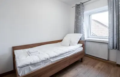 Łóżko lub łóżka w pokoju w obiekcie Apartamenty ZYGFRYD 28C/3/2