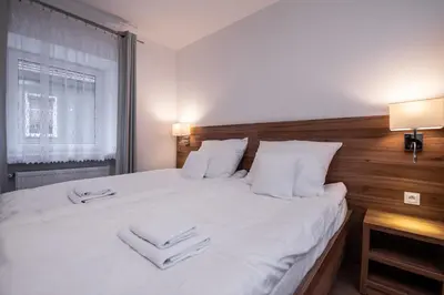Łóżko lub łóżka w pokoju w obiekcie Apartamenty ZYGFRYD 28C/3/2