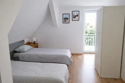 Łóżko lub łóżka w pokoju w obiekcie Dom Przyjaźni
