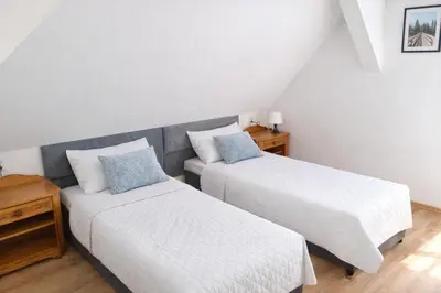 Łóżko lub łóżka w pokoju w obiekcie Dom Przyjaźni