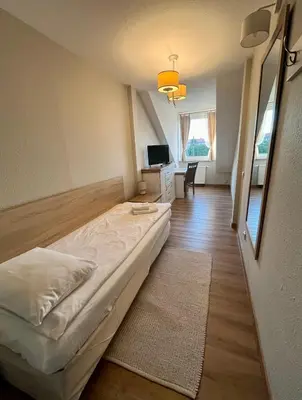 Łóżko lub łóżka w pokoju w obiekcie Hotel Nad Stawem