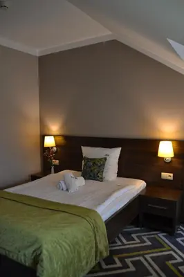 Łóżko lub łóżka w pokoju w obiekcie Hotel & Browar Słociak
