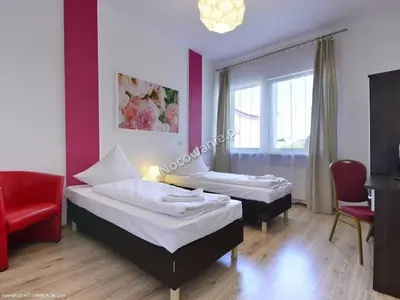 Łóżko lub łóżka w pokoju w obiekcie Hotelik Kameleon Pokoje Gościnne