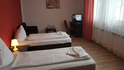 Łóżko lub łóżka w pokoju w obiekcie Hotelik Kameleon Pokoje Gościnne