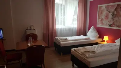 Łóżko lub łóżka w pokoju w obiekcie Hotelik Kameleon Pokoje Gościnne
