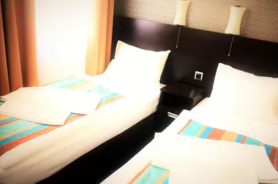Łóżko lub łóżka w pokoju w obiekcie Hotel Kamienica