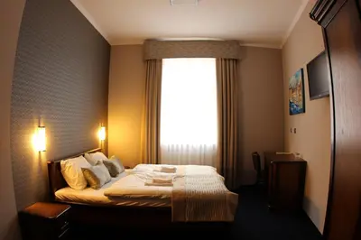 Łóżko lub łóżka w pokoju w obiekcie Hotel Kamienica