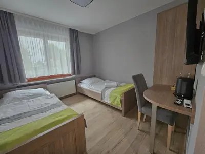 Łóżko lub łóżka w pokoju w obiekcie Restauracja i Noclegi Pod Kasztanami