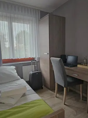 Łóżko lub łóżka w pokoju w obiekcie Restauracja i Noclegi Pod Kasztanami