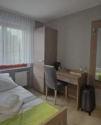 Łóżko lub łóżka w pokoju w obiekcie Restauracja i Noclegi Pod Kasztanami
