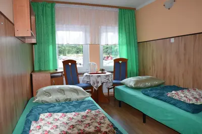 Łóżko lub łóżka w pokoju w obiekcie Ośrodek Wypoczynkowy Pod Szczelińcem