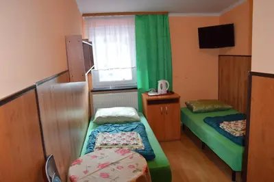Łóżko lub łóżka w pokoju w obiekcie Ośrodek Wypoczynkowy Pod Szczelińcem