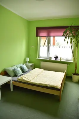 Łóżko lub łóżka w pokoju w obiekcie Apartament Centrum