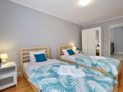 Łóżko lub łóżka w pokoju w obiekcie Apartament w Mieście