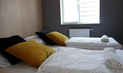 Łóżko lub łóżka w pokoju w obiekcie Apartamenty Miku