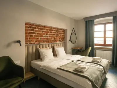 Łóżko lub łóżka w pokoju w obiekcie Arte-locum Apartamenty przy Rynku