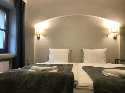 Łóżko lub łóżka w pokoju w obiekcie Arte-locum Apartamenty przy Rynku