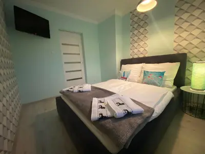 Łóżko lub łóżka w pokoju w obiekcie Blue Sky Apartament