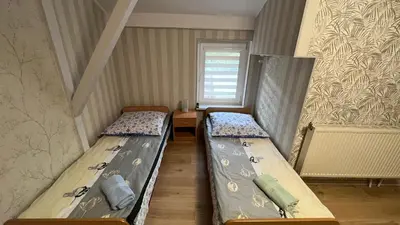 Łóżko lub łóżka w pokoju w obiekcie Willa Justynka