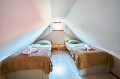 Łóżko lub łóżka w pokoju w obiekcie Domek Pod Lasem