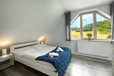 Łóżko lub łóżka w pokoju w obiekcie Apartamenty Cichy Zakątek