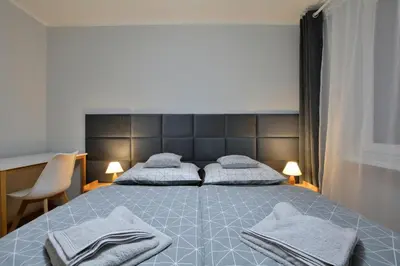 Łóżko lub łóżka w pokoju w obiekcie Apartament Dzień Dobry 3