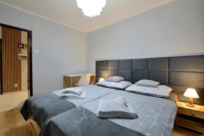 Łóżko lub łóżka w pokoju w obiekcie Apartament Dzień Dobry 3
