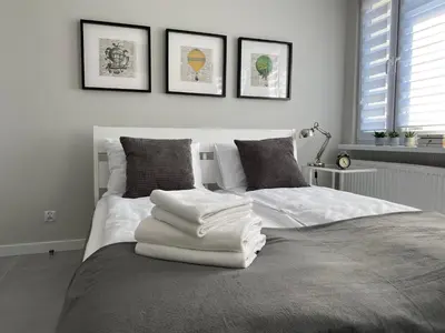 Łóżko lub łóżka w pokoju w obiekcie APARTAMENT OŚ. BŁĘKITNE 10H