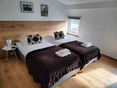 Łóżko lub łóżka w pokoju w obiekcie OficynaApartments
