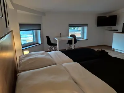 Łóżko lub łóżka w pokoju w obiekcie OficynaApartments
