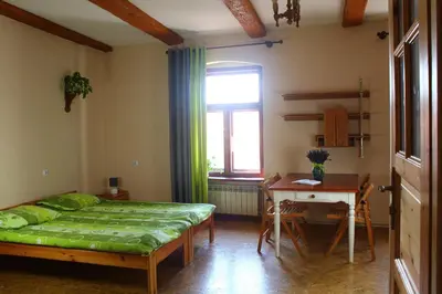 Łóżko lub łóżka w pokoju w obiekcie Apartamenty i pokoje gościnne