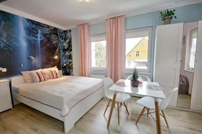 Łóżko lub łóżka w pokoju w obiekcie Apartament Gałązka Jabłoni