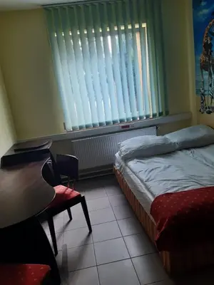 Łóżko lub łóżka w pokoju w obiekcie Noclegi Tyniec