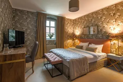 Łóżko lub łóżka w pokoju w obiekcie Zamek Sarny - Schloss Scharfeneck