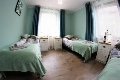 Łóżko lub łóżka w pokoju w obiekcie Apartamenty Zielone Centrum