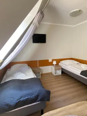 Łóżko lub łóżka w pokoju w obiekcie Willa Jarzębina