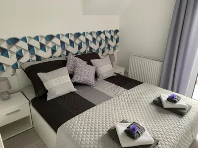 Łóżko lub łóżka w pokoju w obiekcie Apartamenty Pod Cisem