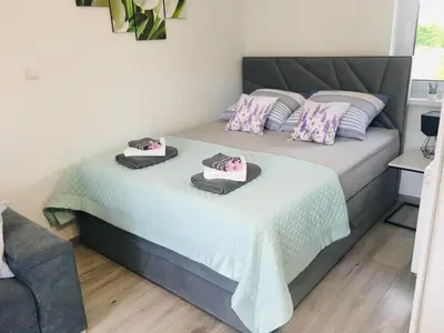 Łóżko lub łóżka w pokoju w obiekcie Apartamenty Pod Cisem