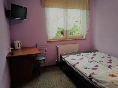 Łóżko lub łóżka w pokoju w obiekcie Na Skwerku