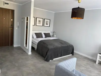 Łóżko lub łóżka w pokoju w obiekcie APARTAMENT OŚ. ZŁOTE 4B