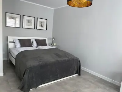 Łóżko lub łóżka w pokoju w obiekcie APARTAMENT OŚ. ZŁOTE 4B