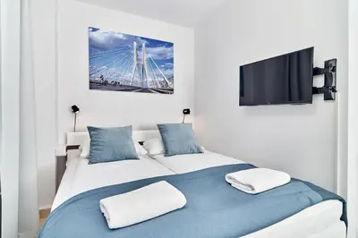 Łóżko lub łóżka w pokoju w obiekcie Apartments Wroclaw Pulaskiego by Noclegi Renters