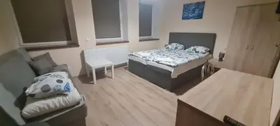 Łóżko lub łóżka w pokoju w obiekcie NOCLEGI Niemodlin
