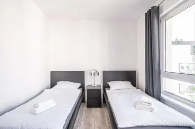 Łóżko lub łóżka w pokoju w obiekcie RentPlanet - Apartamenty Na Grobli