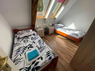 Łóżko lub łóżka w pokoju w obiekcie Apartament pod Stożkiem