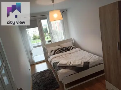 Łóżko lub łóżka w pokoju w obiekcie CITY VIEW Zamenhofa