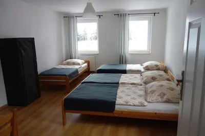 Łóżko lub łóżka w pokoju w obiekcie Dom Gościnny Tatra Nova